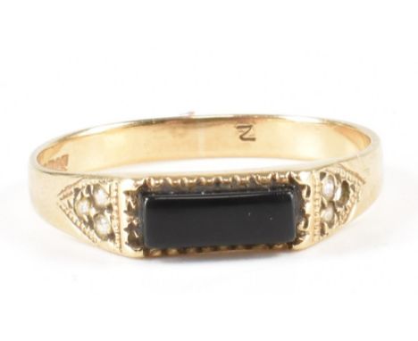 A vintage 9ct gold onyx and white stone ring. The ring having a rectangle onyx stone and white stones to incised shoulders on