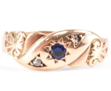 An early 20th Century Edwardian hallmarked 9ct gold and sapphire ring. The ring having a scroll design head set with a round 