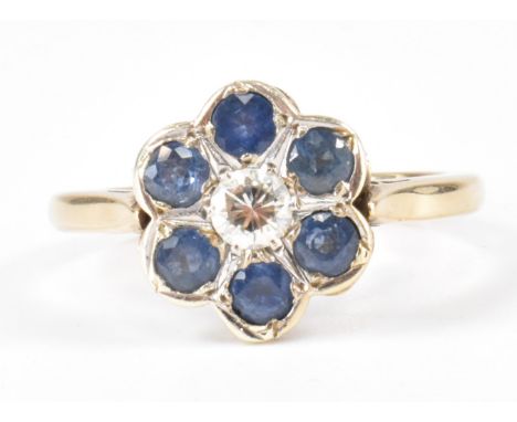 A vintage 20th Century gold, diamond and sapphire flower head ring The ring being set with a central round brilliant cut diam