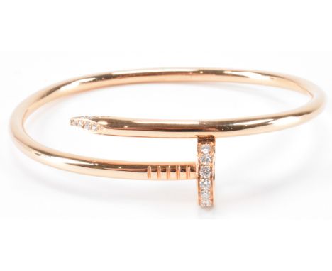 A Cartier 18ct rose gold and diamond Juste Un Clou bracelet. The bangle of coiled nail form having fifteen round brilliant cu