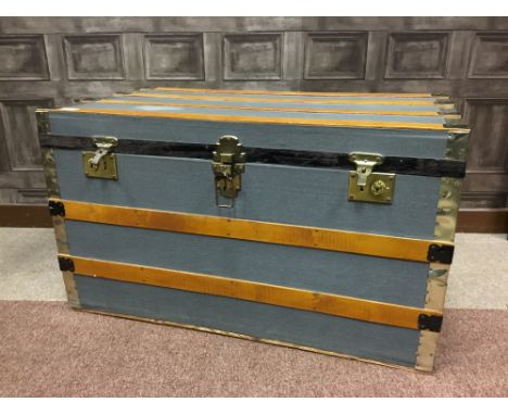 BRASS AND CLOTH BOUND WOODEN TRUNK, with two locks, lacking key, 90cm wide