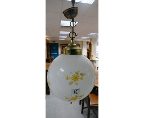 Vintage brass hanging lamp with a white floral decorated glass shade 