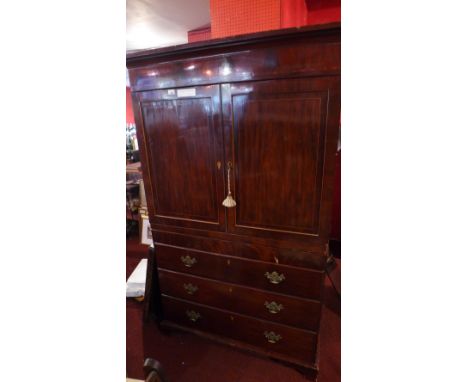 An early 19th century mahogany linen press fitted pair of panel doors above three long drawers on bracket feet 