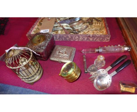 A collection of items, including a watch in a silver and leather case, birdcage clock, a bullseye clock, a silver and rock cr