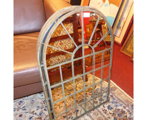 A set of four wrought iron architectural style garden mirrors with arched plates 