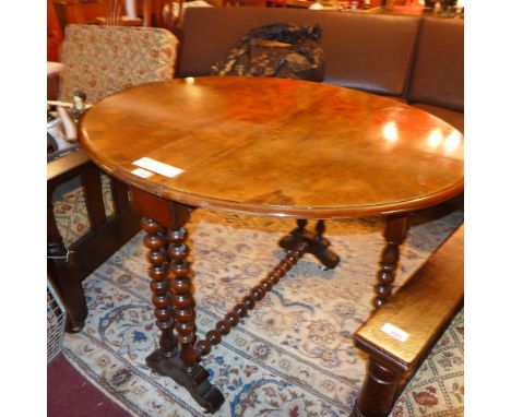 A Victorian burr walnut Sutherland table having twin flaps and gateleg bobbin turned supports  