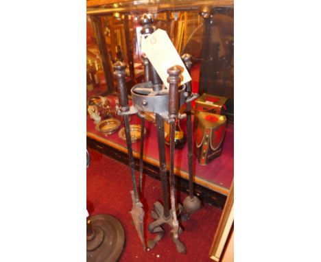 A wrought iron set of fireside tools, on stand 