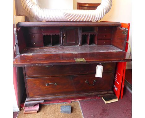 An early 19th century George III and later adapted secretaire chest, having fitted fall front over two long drawers raised on