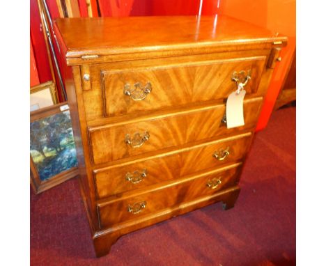 A mahogany bachelors chest the foldover top above four long drawers with brass plate handles on bracket feet