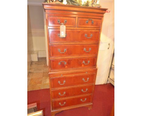 A Georgian style yew wood chest on chest fitted arrangement of drawers and brushing slide on bracket feet