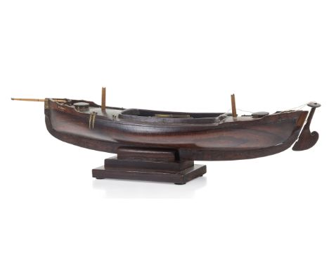 AN ATTRACTIVE MODEL OF A LUG-RIGGED, DROP-KEEL CANOE, CIRCA 1890the 19in. carved hull carved from the solid, with rudder and 