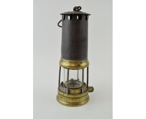 Miners lamp with brass base. Original plate with miners ID. Height 26cm.  