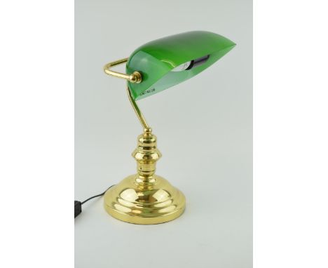 A bankers lamp with brass base and green glass shade. Height 36cm.  