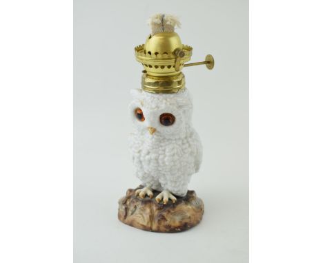 19th century continental porcelain oil lamp in the form of a standing owl, with glass eys, naturalistic base, 23cm tall.  Goo