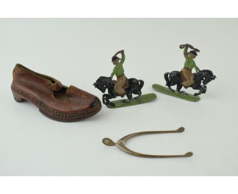 A collection of items to include a pair of silver sugar tongs in the form of a wishbone, two toy lead cowboy figures and a ha