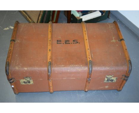 A travel trunk with wooden banding and brass catches. Inner tray present and clean. Leather straps to both ends. 53cm x 85cm 