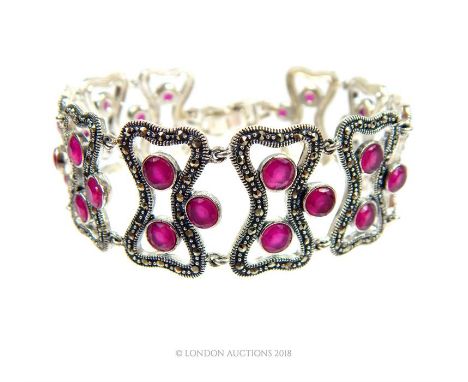 A striking, sterling silver, marcasite and ruby-studded, ten-panel bracelet, totalling thirty, round, faceted, natural pink r