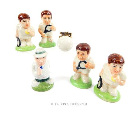  Five “HP" ceramic, caricature tennis player condiment cellars (approximately 10cm high) together with a tennis ball form lig