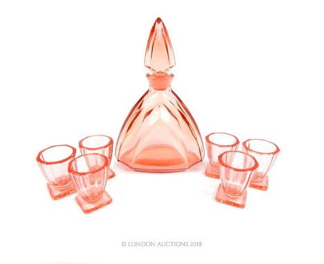 An Art Deco, stepped, pink crystal decanter and pointed stopper with six matching shot glasses on squared bases. Decanter: 21
