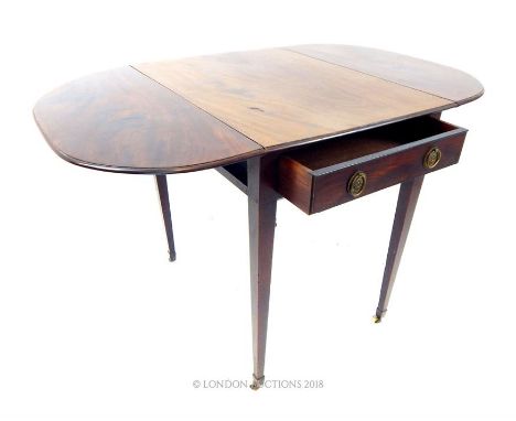 A Georgian, mahogany, Pembroke table with a drawer at either end with brass handles, on four tapered, squared supports on bra