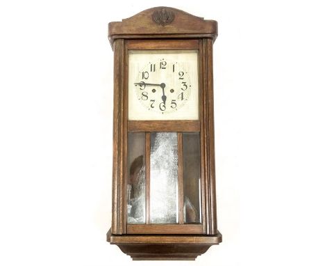 An early 20th century, oak and glazed, cased clock (8 hour movement) with a silvered metal dial with large, black Arabic nume