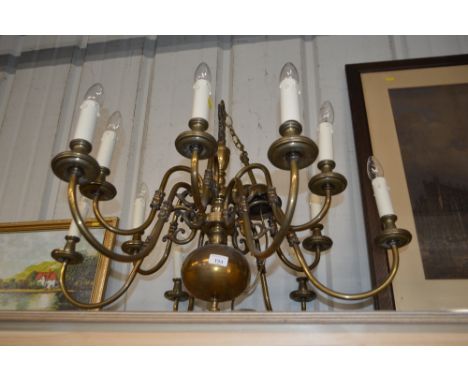 A large brass twelve branch chandelier
