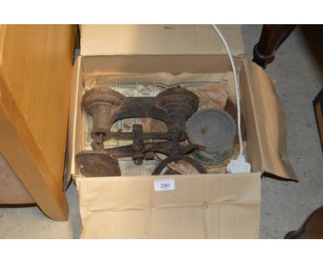 A box containing a set of kitchen scales 