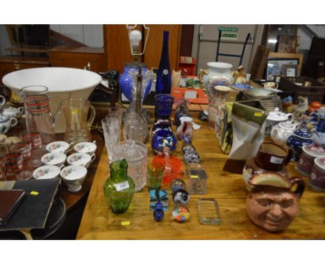 A quantity of various glassware to include heavy glass lamp, glass decanter, cut glass jar and cover, paperweight etc. 