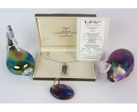 A Glasform iridescent glass pig paperweight 7cm high, a Glasform fish paperweight, both signed to base and with paper label, 