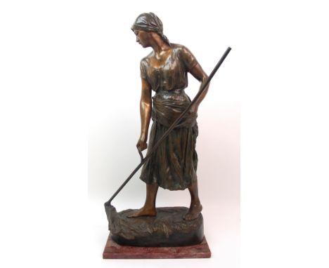 A large Goldscheider patinated bronze of a girl holding a scythe incised Clerc to front, and with foundry mark to reverse, lo