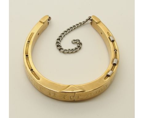 A 15ct gold horseshoe shaped bangle with sprung hinge, engraved with Wear It For Good Luck' needs a clasp to make it more sec
