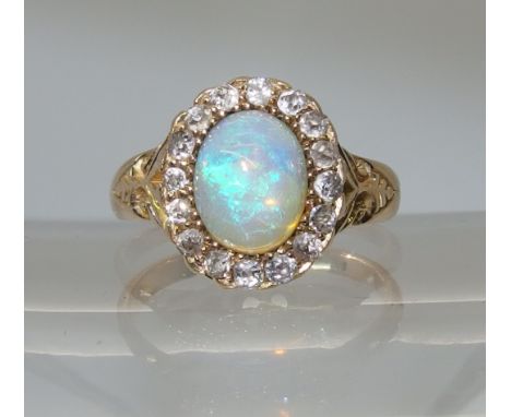 An 18ct yellow gold jelly opal and old cut diamond ring the translucent jelly opal has good blue green colour play and is sur