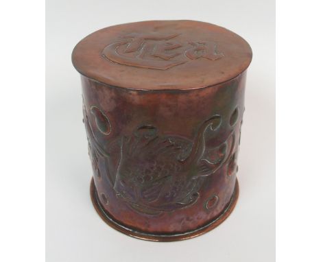 A Newlyn Copper circular tea caddy relief decorated with fish and bubbles on a hammered ground, the lid incised Tea, impresse