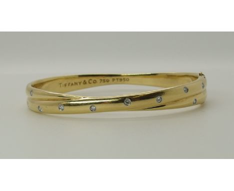 An 18ct yellow gold and diamond Tiffany bangle the double hoop shape studded with diamonds to an estimated approx diamond con