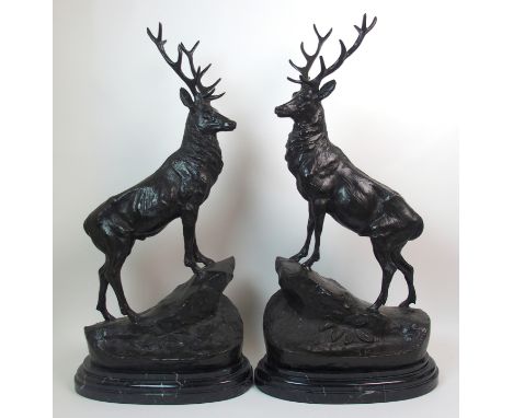 After Jules Moigniez - A pair of bronze stags moulded on rocky outcrops, upon marble bases, 73.5cm high including base (2)