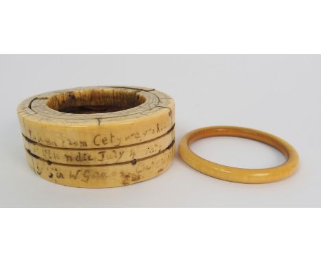 An African ivory slave necklet with horizontal banding and script "Taken from Cetyura, july 4th...etc', 12.5 cm diam and an i