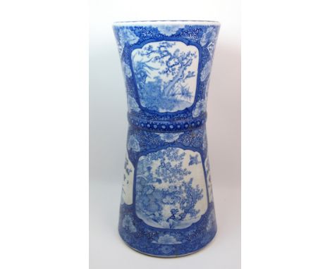 An Arita blue and white stick stand painted with panels of dragons, birds and flowers, signed, 62cm high