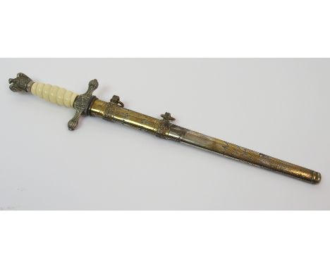 A Second World War German Naval dagger the double fullered blade unmarked, the celluloid hilt crossguard with fouled anchors 