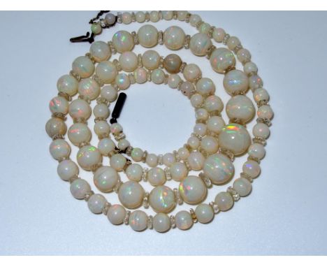 A string of white opal beads interspaced with clear facet cut glass beads, largest opal bead 11mm, smallest opal 4mm, length 