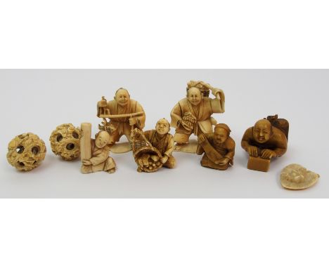 A group of carvings comprising; man holding fruit, signed, 5cm high, man weighing fish, signed, 5cm high, netsuke with man an
