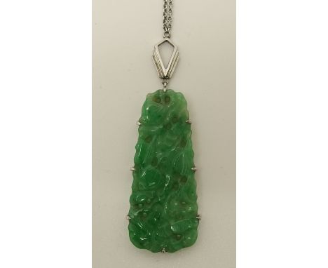 A Chinese green hardstone pendant carved with fruit and foliage, set in a 9ct white gold pendant mount and chain, in original