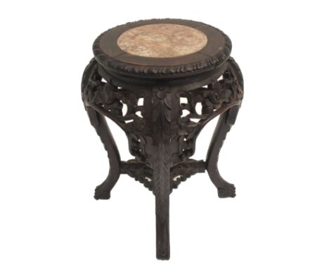 A Chinese hardwood plant pedestal with inset marble top above carved foliate apron and on four scroll legs, 48cm high