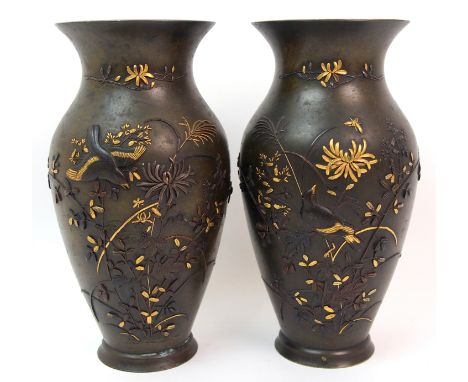 A pair of Japanese bronze baluster vases cast with birds and insects amongst various flowers, (one with small dent to body, t