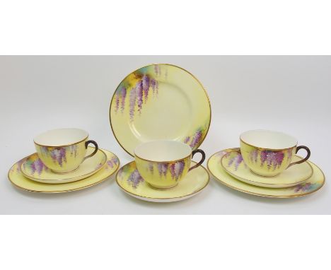 Three Royal Worcester trios each cup, saucer and plate painted with wisteria on a lemon yellow ground, signed H. Everett, pla