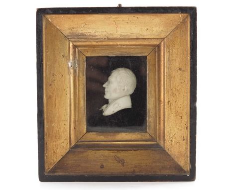 λ A 19th century Dieppe carved ivory portrait bust, relief modelled in profile as a gentleman, 5.5cm long, framed