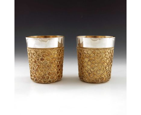 Stuart Devlin, a pair of Modernist silver and parcel gilt beakers, London 1978, conical form with blind reticulated rusticate