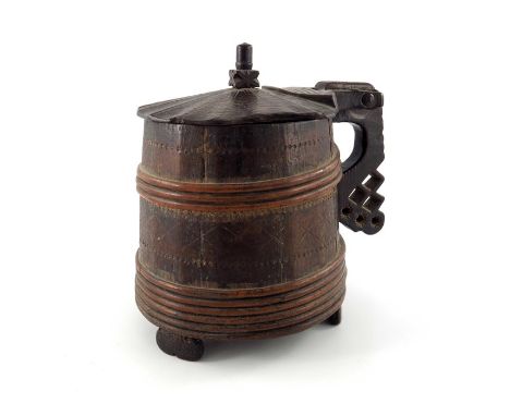 An 18th century Scandinavian peg tankard, willow-bound and chip-carved with geometric motifs, hinged cover with central finia