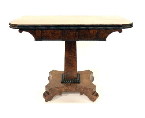 A William IV yew wood pedestal fold over card table, square section tapered column support on a horn scroll bracket base, wit