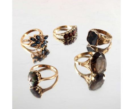 Five 9 carat gold gem set rings, including opal, garnet and bloodstone, together with smoky quartz and blue and white stone, 