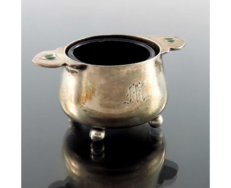 An Arts and Crafts silver and enamelled salt cellar, James Fenton, Birmingham 1906, twin handled conical cauldron form, with 